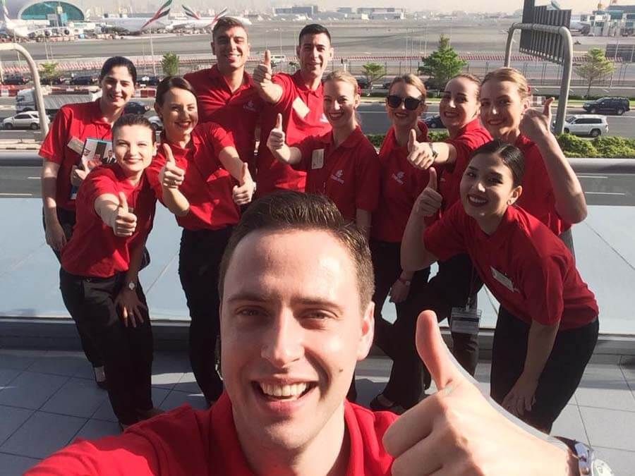 New Emirates cabin crew wearing red training shirts before Emirates Aviation College classes.